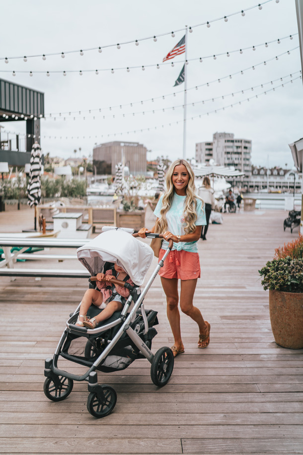 Lifestyle Blogger Katelyn Jones of a Touch of Pink Blog walking her baby in the Uppababy Vista stroller 
