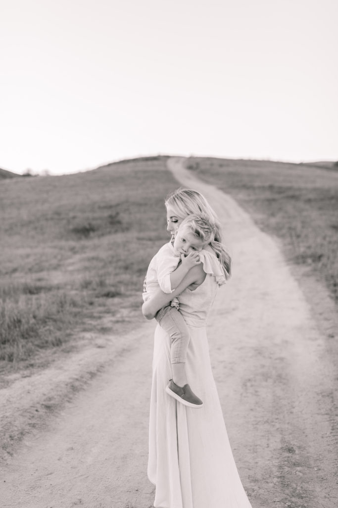 Katelyn Jones A Touch of Pink Blog Family Photoshoot with Reshma Photography in Southern California Orange County. Katelyn holding son Dane in black and white photo.