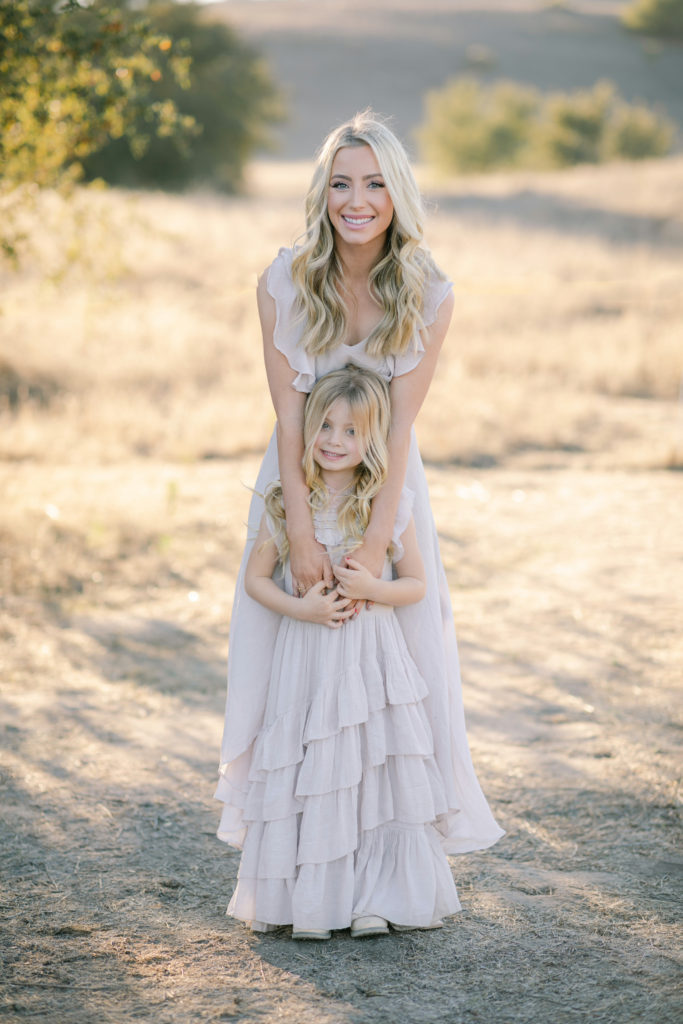 Katelyn Jones A Touch of Pink Blog Family Photoshoot with Reshma Photography. Katelyn smiling with daughter Kennedy