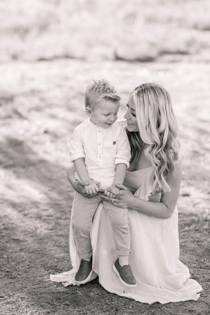 Katelyn Jones A Touch of Pink Blog Family Photoshoot with Reshma Photography in Southern California Orange County. Son Dane Smiling for photo with mom Katelyn