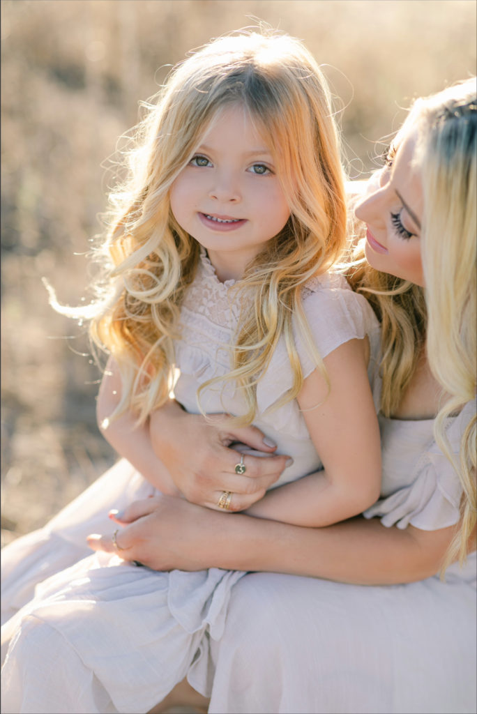 Katelyn Jones A Touch of Pink Blog Family Photoshoot with Reshma Photography in Southern California Orange County. Daughter Kennedy Smiling for photo with mom Katelyn