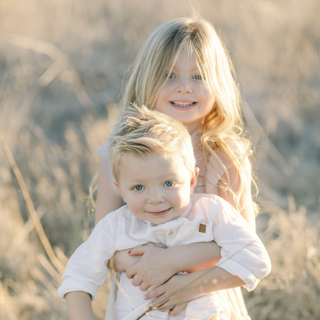 Katelyn Jones A Touch of Pink Blog Family Photoshoot with Reshma Photography in Southern California Orange County. Toddler girl and toddler boy smiling for photo