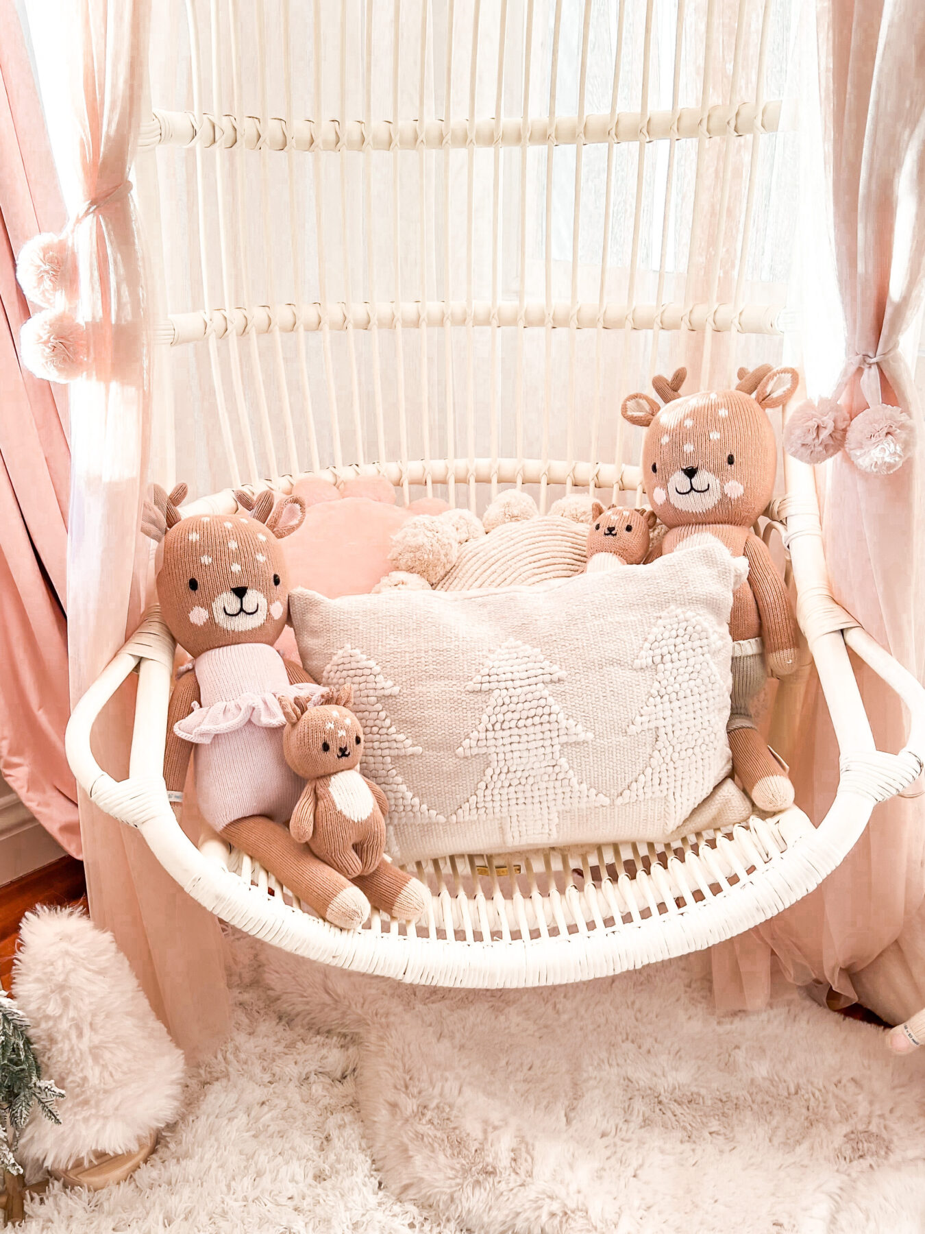 Pink Christmas Decor  little girl Christmas bedroom Katelyn Jones A Touch of Pink Blog Pink Christmas Decor Hanging Rattan Chair Cuddle and Kind Reindeer Dolls