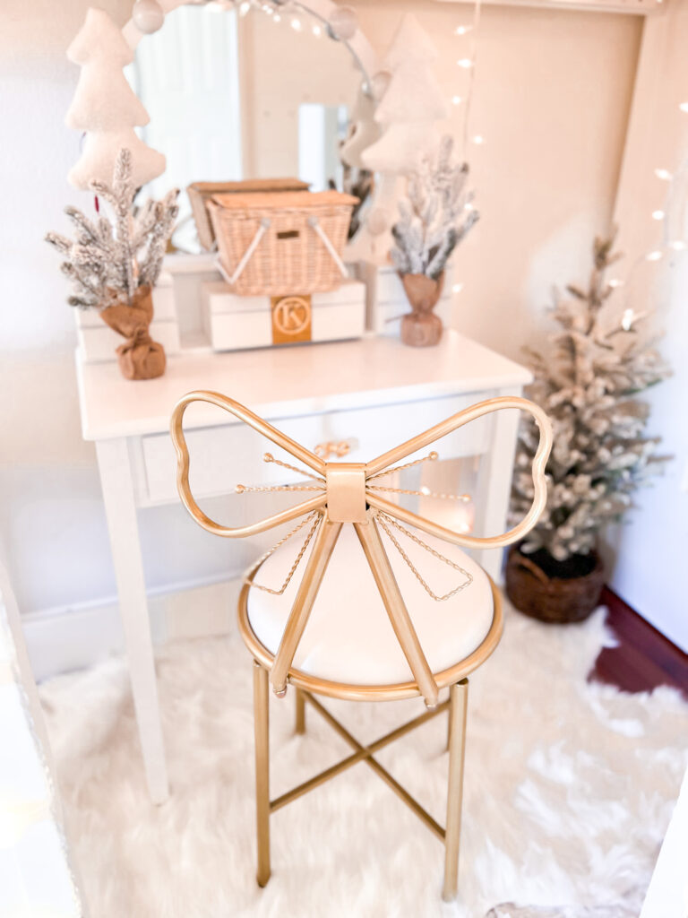 Pink Christmas Decor little girl Christmas bedroom Katelyn Jones A Touch of Pink white vanity with metal gold bow chair