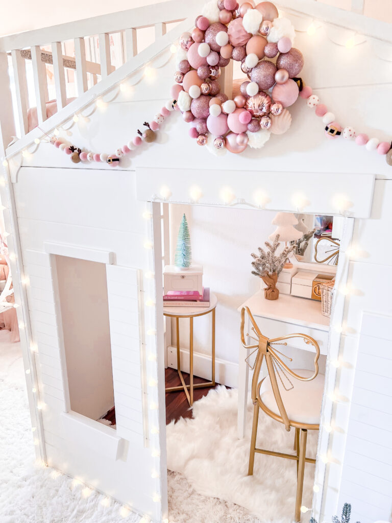 Pink Christmas Decor little girl Christmas bedroom Katelyn Jones A Touch of Pink white vanity with metal gold bow chair Pottery Barn Loft Bed pearl and jane pom pom garland